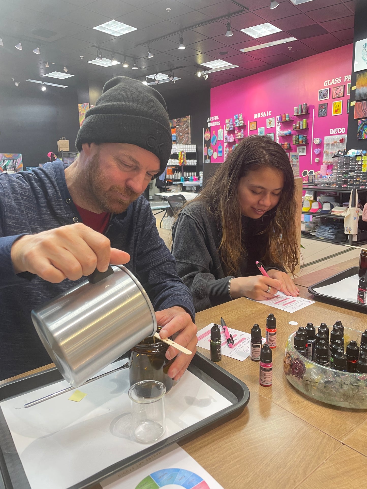 Guest pouring a custom soy candle during the Founder's Scent Experience in Pleasanton