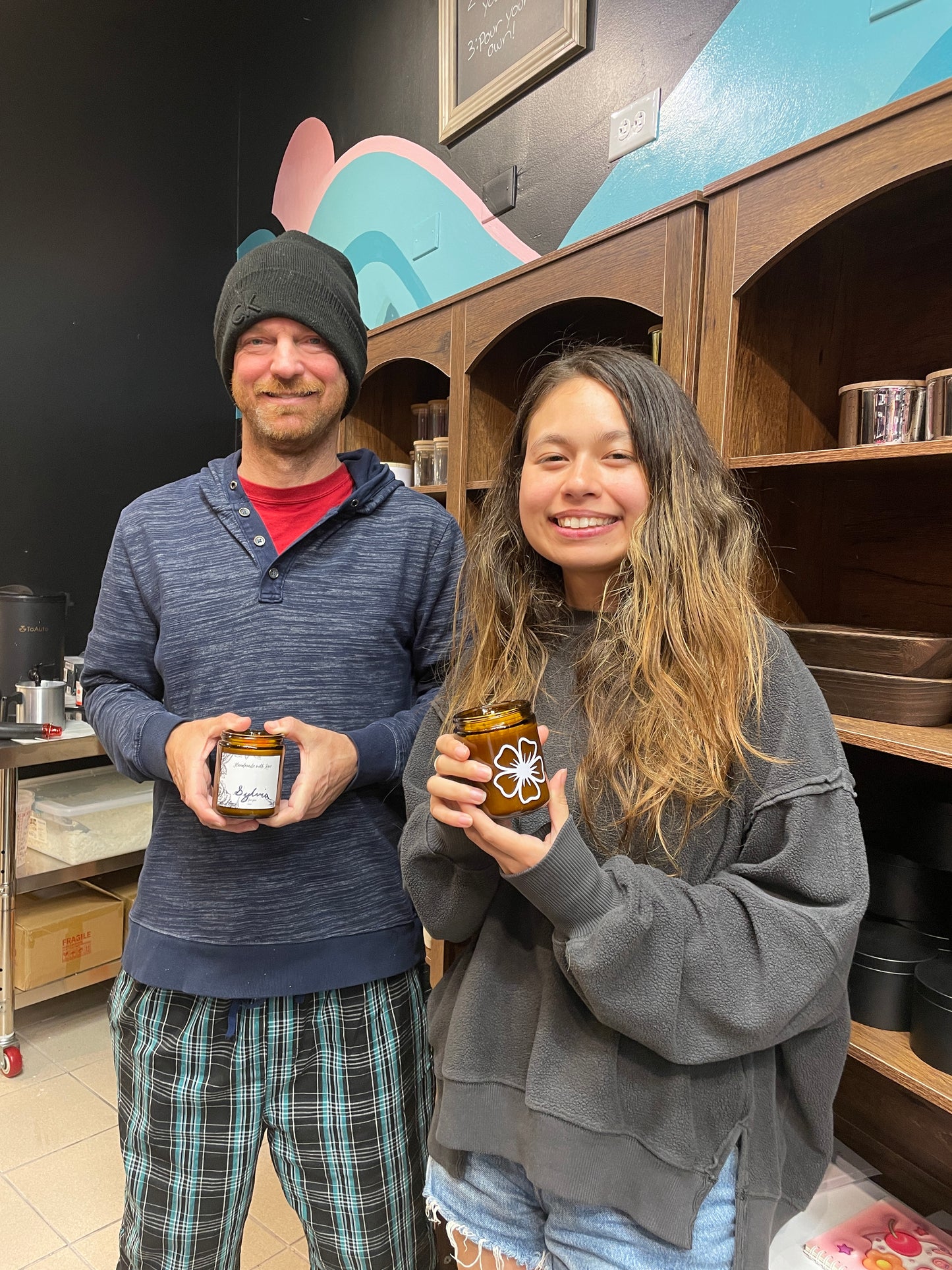 Father and daughter holding finished custom candles at Makers Art Studio Pleasanton