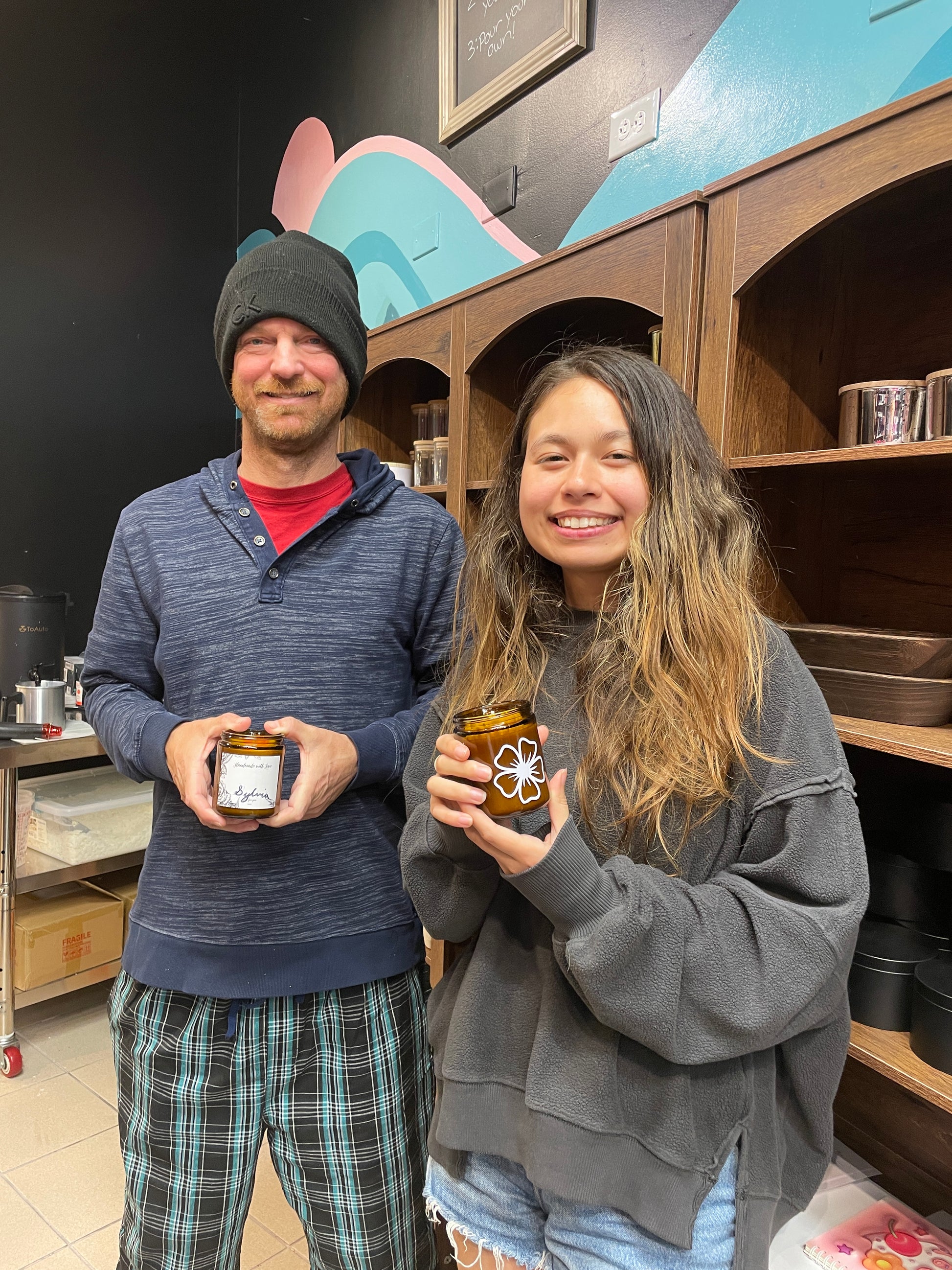 Father and daughter holding finished custom candles at Makers Art Studio Pleasanton